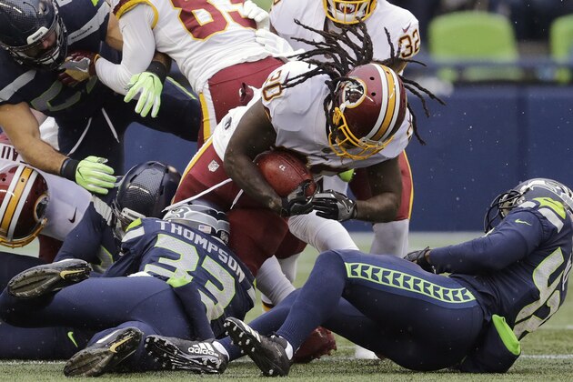 Washington Redskins running back Rob Kelley (20) is tackled by Seattle Seahawks free safety Tedric Thompson (33) while rushing in the first half of an NFL football game, Sunday, Nov. 5, 2017, in Seattle. (AP Photo/Stephen Brashear)