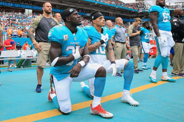 MIAMI GARDENS, FL - NOVEMBER 06:  Michael Thomas #31 of the Miami Dolphins and  Kenny Stills #10 of the Miami Dolphins take a knee during the national anthem prior to the game against the New York Jets at the Hard Rock Stadium on November 6, 2016 in Miami Gardens, Florida.  (Photo by Chris Trotman/Getty Images)