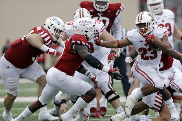 Wisconsin running back Jonathan Taylor (23) runs past Indiana's Tegray Scales (8) for a 32-yard touchdown run during the second half of an NCAA college football game, Nov. 4, 2017, in Bloomington, Ind. Wisconsin won 45-17. (AP Photo/Darron Cummings)
