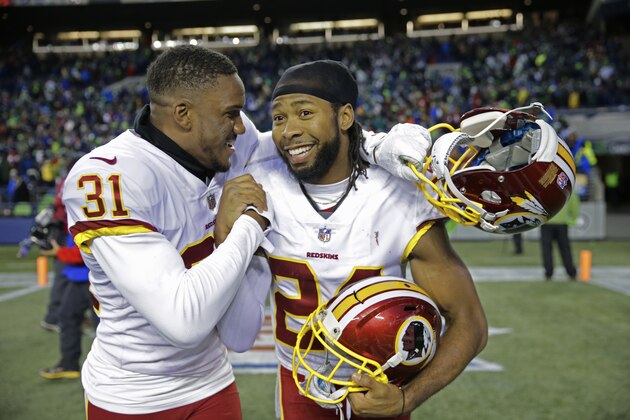 Washington Redskins cornerbacks Josh Norman, right, and Fabian Moreau, left, celebrate after an NFL football game against the Seattle Seahawks, Sunday, Nov. 5, 2017, in Seattle. Washington won 17-14. (AP Photo/Stephen Brashear)