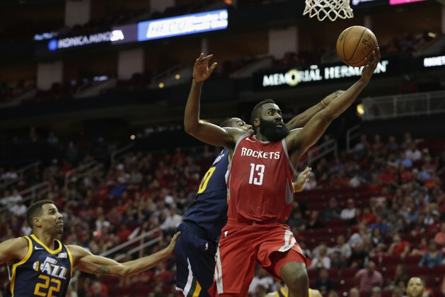 HOUSTON, TX - NOVEMBER 05:  James Harden #13 of the Houston Rockets shoots a lay up in the second half defended by Alec Burks #10 of the Utah Jazz at Toyota Center on November 05, 2017 in Houston, Texas.  NOTE TO USER: User expressly acknowledges and agrees that, by downloading and or using this photograph, User is consenting to the terms and conditions of the Getty Images License Agreement.  (Photo by Tim Warner/Getty Images)