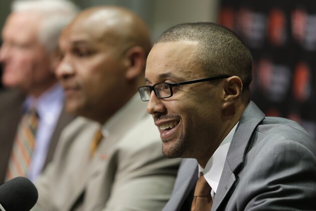 Executive Vice President of Football Operations Sashi Brown, right, addresses the media during a news conference, Wednesday, Jan. 13, 2016, in Berea, Ohio.  (AP Photo/Tony Dejak)