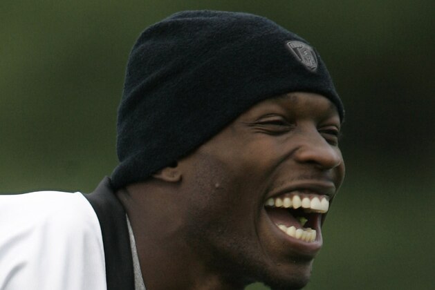 ** FILE ** This July 28, 2008 file photo shows Cincinnati Bengals receiver Ocho Cinco laughing during team practice in Georgetown, Ky. Asked if his one-game benching for having a verbal altercation with a Cincinnati Bengals coach has taught him anything, receiver Ocho Cinco paused for several seconds before smiling and giving a one-word answer. No, he said, then tried to move on. (AP Photo/Al Behrman, File)