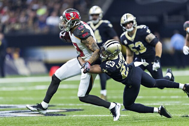 NEW ORLEANS, LA - NOVEMBER 5:  Mike Evans #13 of the Tampa Bay Buccaneers is tackled from behind by Marshon Lattimore #23 of the New Orleans Saints at Mercedes-Benz Superdome on November 5, 2017 in New Orleans, Louisiana.  The Saints defeated the Buccaneers 30-10. (Photo by Wesley Hitt/Getty Images)