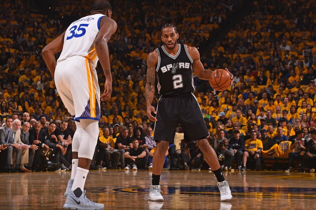 OAKLAND, CA - MAY 14:  Kawhi Leonard #2 of the San Antonio Spurs dribbles the ball while guarded by Kevin Durant #35 of the Golden State Warriors in Game One of the Western Conference Finals during the 2017 NBA Playoffs on May 14, 2017 at ORACLE Arena in Oakland, California. NOTE TO USER: User expressly acknowledges and agrees that, by downloading and or using this photograph, user is consenting to the terms and conditions of Getty Images License Agreement. Mandatory Copyright Notice: Copyright 2017 NBAE (Photo by Noah Graham/NBAE via Getty Images)