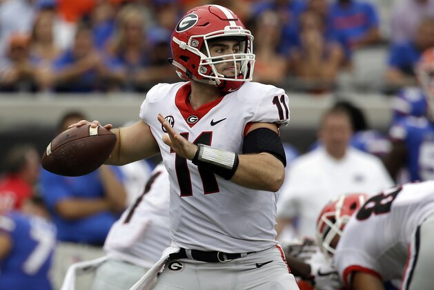 FILE - In this Saturday, Oct. 28, 2017 file photo, Georgia quarterback Jake Fromm throws a pass against Florida in the first half of an NCAA college football game in Jacksonville, Fla. Jake Fromm hardly looks like someone who was playing high school football a year ago. He stepped right in when Georgia's starter was injured in the very first game. The No. 2 Bulldogs are trying to become only the second team to win a national title with a true freshman quarterback. (AP Photo/John Raoux, File)