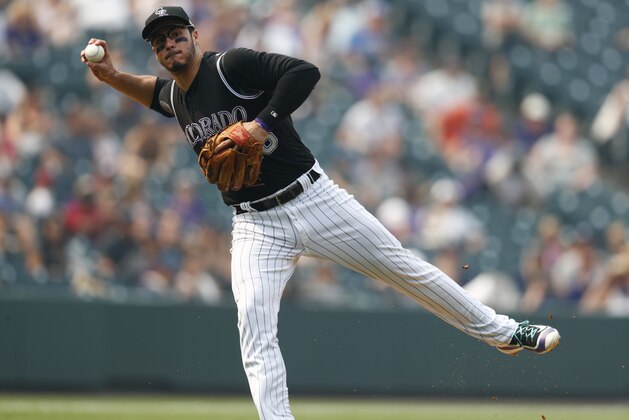Colorado Rockies third baseman Nolan Arenado throws to first base to put out San Francisco Giants' Mac Williamson in the fifth inning of a baseball game, Monday, Sept. 4, 2017, in Denver. The Rockies won 4-3. (AP Photo/David Zalubowski)