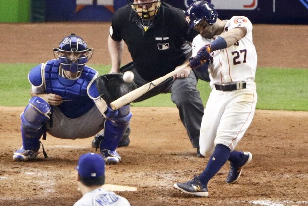 Houston Astros' Jose Altuve hits a three-run home run off Los Angeles Dodgers pitcher Kenta Maeda, of Japan, during the fifth inning of Game 5 of baseball's World Series Sunday, Oct. 29, 2017, in Houston. (AP Photo/Charlie Riedel)
