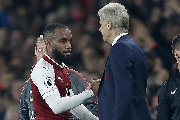 Arsenal's French striker Alexandre Lacazette (L) shakes habds with Arsenal's French manager Arsene Wenger as he is substituted off of the pitch during the English Premier League football match between Arsenal and West Bromwich Albion at the Emirates Stadium in London on September 25, 2017.  / AFP PHOTO / Ian KINGTON / RESTRICTED TO EDITORIAL USE. No use with unauthorized audio, video, data, fixture lists, club/league logos or 'live' services. Online in-match use limited to 75 images, no video emulation. No use in betting, games or single club/league/player publications.  /         (Photo credit should read IAN KINGTON/AFP/Getty Images)