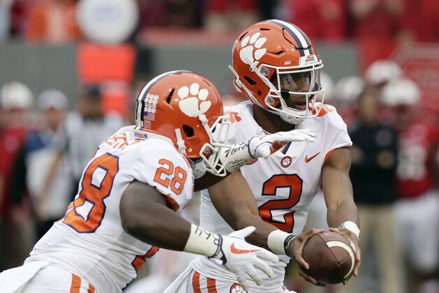 Clemson quarterback Kelly Bryant (2) hands off to Tavien Feaster (28) during the first half of an NCAA college football game against North Carolina State in Raleigh, N.C., Saturday, Nov. 4, 2017. (AP Photo/Gerry Broome)