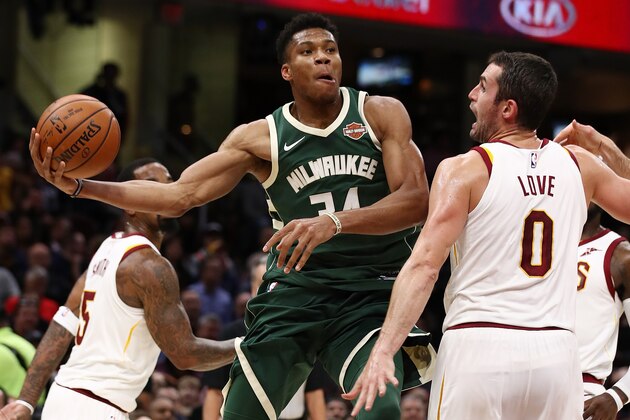 CLEVELAND, OH - NOVEMBER 07:  Giannis Antetokounmpo #34 of the Milwaukee Bucks passes around Kevin Love #0 of the Cleveland Cavaliers during the first half at Quicken Loans Arena on November 7, 2017 in Cleveland, Ohio. NOTE TO USER: User expressly acknowledges and agrees that, by downloading and or using this photograph, User is consenting to the terms and conditions of the Getty Images License Agreement.  (Photo by Gregory Shamus/Getty Images)