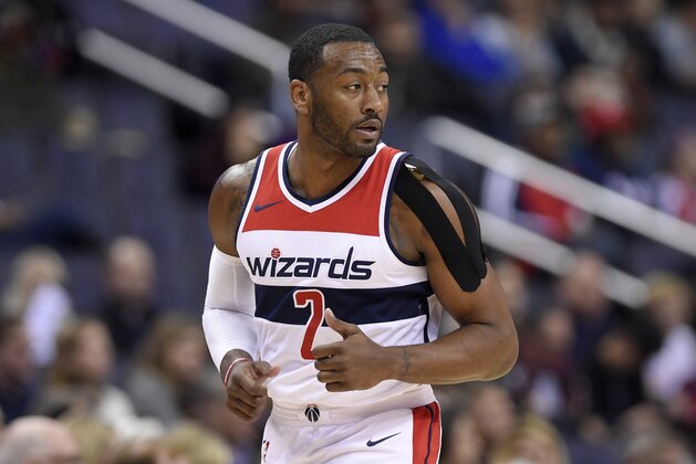 Washington Wizards guard John Wall (2) runs down the court with a heavily taped shoulder during the first half of an NBA basketball game against the Dallas Mavericks, Tuesday, Nov. 7, 2017, in Washington. (AP Photo/Nick Wass)