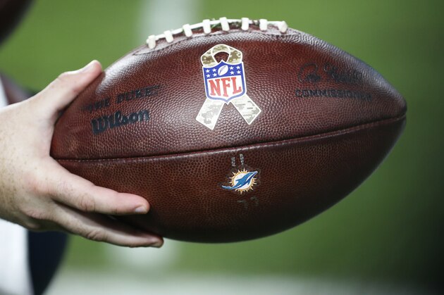 An NFL football with a Salute to Service logo, during the first half of an NFL football game between the Miami Dolphins and the Oakland Raiders, Sunday, Nov. 5, 2017, in Miami Gardens, Fla. (AP Photo/Wilfredo Lee)