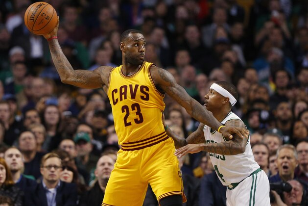 Cleveland Cavaliers forward LeBron James holds the ball away from Boston Celtics guard Isaiah Thomas during the second quarter of a NBA basketball game in Boston Tuesday, Dec. 15, 2015. (AP Photo/Winslow Townson)