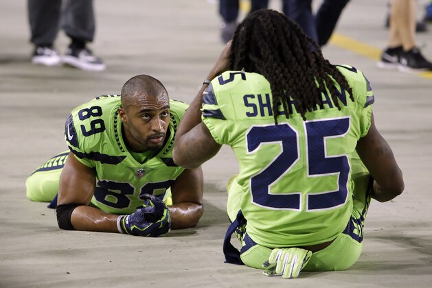 Seattle Seahawks wide receiver Doug Baldwin (89) and cornerback Richard Sherman (25) sit on the sidelines during the second half of an NFL football game against the Arizona Cardinals, Thursday, Nov. 9, 2017, in Glendale, Ariz. (AP Photo/Rick Scuteri)
