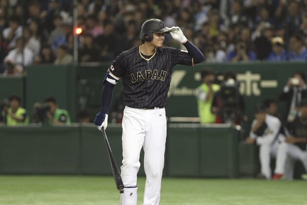Japan’s Shohei Otani greets the umpire while coming to bat in the seventh inning of an international exhibition series baseball game against the Netherlands at Tokyo Dome in Tokyo, Sunday, Nov. 13, 2016. (AP Photo/Toru Takahashi)