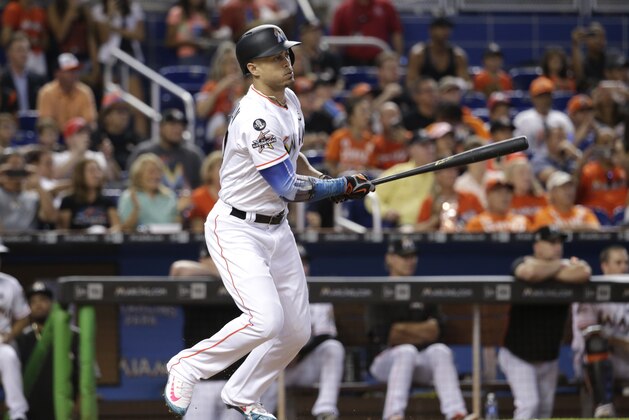 Miami Marlins' Giancarlo Stanton hits a single during the third inning of a baseball game against the Atlanta Braves, Sunday, Oct. 1, 2017, in Miami. (AP Photo/Lynne Sladky)