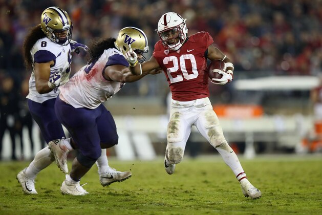 PALO ALTO, CA - NOVEMBER 10:  Bryce Love #20 of the Stanford Cardinal breaks away from Vita Vea #50 of the Washington Huskies at Stanford Stadium on November 10, 2017 in Palo Alto, California.  (Photo by Ezra Shaw/Getty Images)