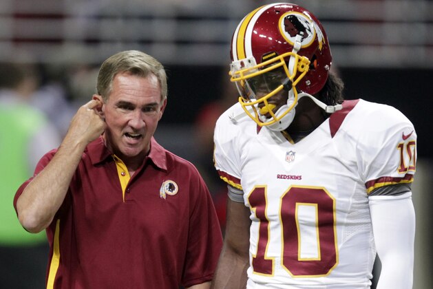 FILE - In this Sept. 16, 2012, file photo, Washington Redskins quarterback Robert Griffin III, right, talks with head coach Mike Shanahan before the start of an NFL football game against the St. Louis Rams in St. Louis, Mo. Shanahan says from now on he's going to make sure that Griffin