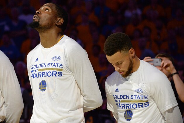 OAKLAND, CA - JUNE 12:  Kevin Durant #35 and Stephen Curry #30 of the Golden State Warriors during the national anthem before the game against the Cleveland Cavaliers in Game Five of the 2017 NBA Finals on June 12, 2017 at ORACLE Arena in Oakland, California. NOTE TO USER: User expressly acknowledges and agrees that, by downloading and/or using this photograph, user is consenting to the terms and conditions of Getty Images License Agreement. Mandatory Copyright Notice: Copyright 2017 NBAE (Photo by Andrew D. Bernstein/NBAE via Getty Images)