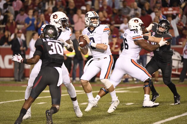 Auburn quarterback Jarrett Stidham (8) drops back to pass against Arkansas in the first half of an NCAA college football game in Fayetteville, Ark., Saturday, Oct. 21, 2017. Auburn beat Arkansas 52-20. (AP Photo/Michael Woods)