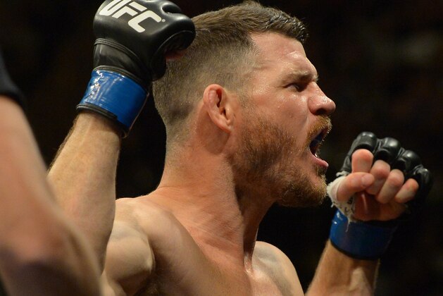 INGLEWOOD, CA - JUNE 04: Michael Bisping raises his arms to the crowd as he enters the cage for his middleweight championship bout at UFC 199 at The Forum on June 4, 2016 in Inglewood, California. (Photo by Jayne Kamin-Oncea/Getty Images)