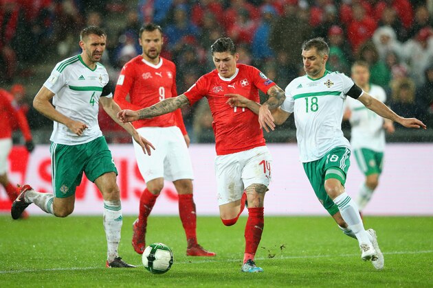 BASEL, SWITZERLAND - NOVEMBER 12:  Steven Zubar of Switzerland and Aaron Hughes of Northern Ireland in action during the FIFA 2018 World Cup Qualifier Play-Off: Second Leg between Switzerland and Northern Ireland at St. Jakob-Park on November 12, 2017 in Basel, Basel-Stadt.  (Photo by Alex Livesey/Getty Images)