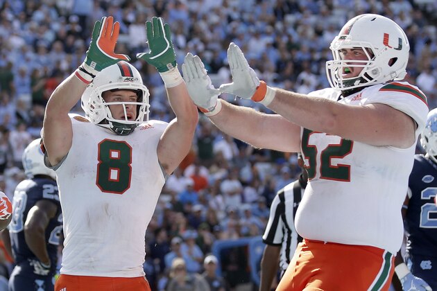 FILE - In this Oct. 28, 2017, file photo, Miami's Braxton Berrios (8) celebrates his touchdown with  KC McDermott (52) during the second half of an NCAA college football game against North Carolina in Chapel Hill, N.C. Berrios has more touchdown catches already this season than in his first three years with the seventh-ranked and unbeaten Hurricanes. He's broken out at the right time for Miami, which takes on No. 3 Notre Dame this weekend in a showdown with national championship implications.  (AP Photo/Gerry Broome, File)