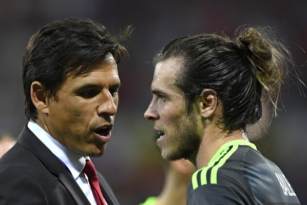 Wales' coach Chris Coleman (L) consols Wales' forward Gareth Bale after Wales lost to portugal 2-0 in the Euro 2016 semi-final football match between Portugal and Wales at the Parc Olympique Lyonnais stadium in Décines-Charpieu, near Lyon, on July 6, 2016.
 / AFP / MIGUEL MEDINA        (Photo credit should read MIGUEL MEDINA/AFP/Getty Images)