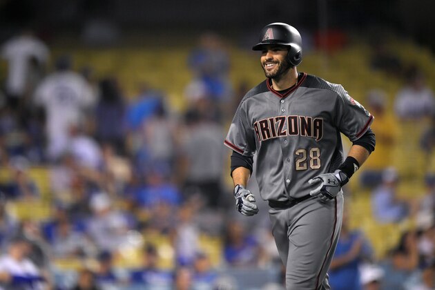 Arizona Diamondbacks' J.D. Martinez smiles as he runs back to the dugout after hitting his fourth home run of the game in the ninth inning of a baseball game against the Los Angeles Dodgers, Monday, Sept. 4, 2017, in Los Angeles. (AP Photo/Mark J. Terrill)