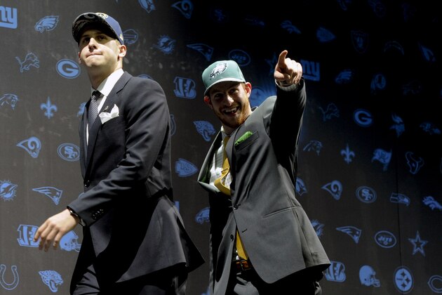 FILE - In this April 28, 2016, file photo, Jared Goff, left, after being selected by Los Angeles Rams as their number one overall pick and Carson Wentz, after being selected by the Philadelphia Eagles as their top pick in the first round of the 2016 NFL football draft, greet fans at Selection Square in Grant Park, in Chicago. Your assignment, as No. 1 overall pick in April's draft who has not gotten on the field yet, but starts Sunday for the Rams against the Dolphins, is simple: win. Just go out and play like fellow rookie quarterbacks Dak Prescott in Dallas and Carson Wentz in Philadelphia have done. (AP Photo/Matt Marton, File)
