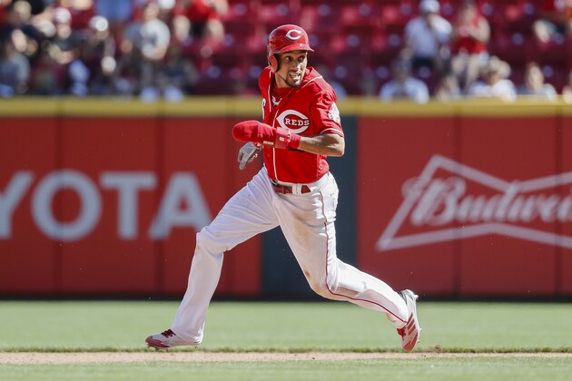 Cincinnati Reds' Billy Hamilton runs home to score on an attempted steal at second and blown pickoff attempt caused by a throwing error by Boston Red Sox second baseman Dustin Pedrioa in the seventh inning of a baseball game, Sunday, Sept. 24, 2017, in Cincinnati. (AP Photo/John Minchillo)