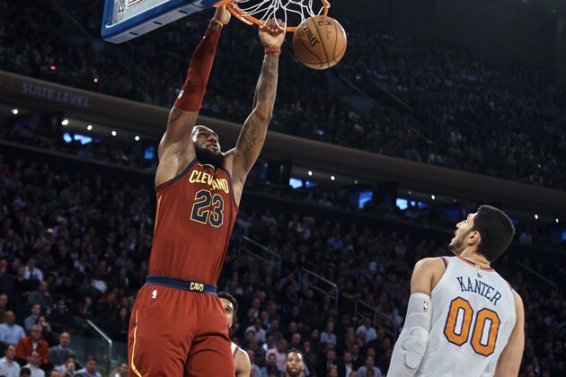 Cleveland Cavaliers' LeBron James, left, dunks over New York Knicks' Enes Kanter (00) during the first half of a NBA basketball game at Madison Square Garden in New York, Monday, Nov. 13, 2017. (AP Photo/Andres Kudacki)