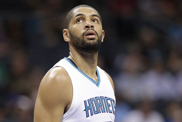 Charlotte Hornets' Nicolas Batum watches a free throw in the first half of an NBA basketball game against the Milwaukee Bucks in Charlotte, N.C., Tuesday, March 28, 2017. (AP Photo/Chuck Burton)