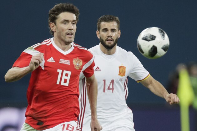 Russia's Yuri Zhirkov, left, struggles for the ball with Spain's Nacho during the international friendly soccer match between Russia and Spain in St.Petersburg, Russia, Tuesday, Nov. 14, 2017. (AP Photo/Dmitri Lovetsky)