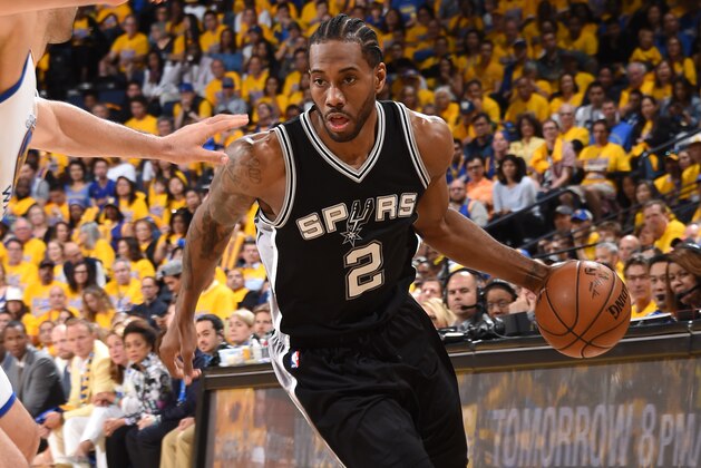 OAKLAND, CA - MAY 14: Kawhi Leonard #2 of the San Antonio Spurs handles the ball against the Golden State Warriors in Game One of the Western Conference Finals of the 2017 NBA Playoffs on May 14, 2017 at ORACLE Arena in Oakland, California. NOTE TO USER: User expressly acknowledges and agrees that, by downloading and/or using this Photograph, user is consenting to the terms and conditions of the Getty Images License Agreement. Mandatory Copyright Notice: Copyright 2017 NBAE (Photo by Andrew D. Bernstein/NBAE via Getty Images)