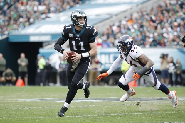 PHILADELPHIA, PA - NOVEMBER 05: Carson Wentz #11 of the Philadelphia Eagles looks to pass while under pressure from Shane Ray #56 of the Denver Broncos during a game at Lincoln Financial Field on November 5, 2017 in Philadelphia, Pennsylvania. The Eagles defeated the Broncos 51-23. (Photo by Joe Robbins/Getty Images)