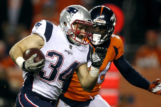 New England Patriots running back Rex Burkhead (34) scores a touchdown as Denver Broncos free safety Darian Stewart (26) pursues during the first half of an NFL football game, Sunday, Nov. 12, 2017, in Denver. (AP Photo/David Zalubowski)