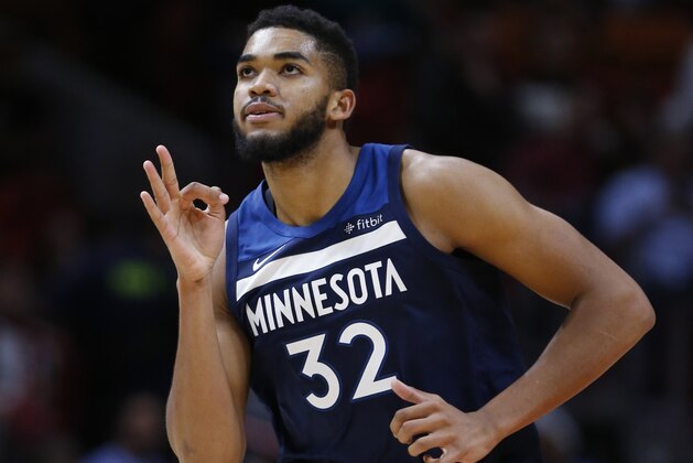 Minnesota Timberwolves center Karl-Anthony Towns celebrates a three-point shot during the second half of an NBA basketball game against the Miami Heat, Monday, Oct. 30, 2017, in Miami. Towns scored 20 points and grabbed 12 rebounds for the Timberwolves as they defeated the Heat 125-122 in overtime. (AP Photo/Wilfredo Lee)