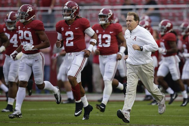 FILE - In this Saturday, Oct. 14, 2017, file photo, Alabama coach Nick Saban and quarterback Jalen Hurts (2) runs onto the field before the team's NCAA college football game against Arkansas in Tuscaloosa, Ala. No. 1 Alabama and No. 3 Georgia are on track to give the SEC two undefeated teams in the championship game for the first time since 2009.  (AP Photo/Brynn Anderson, File)
