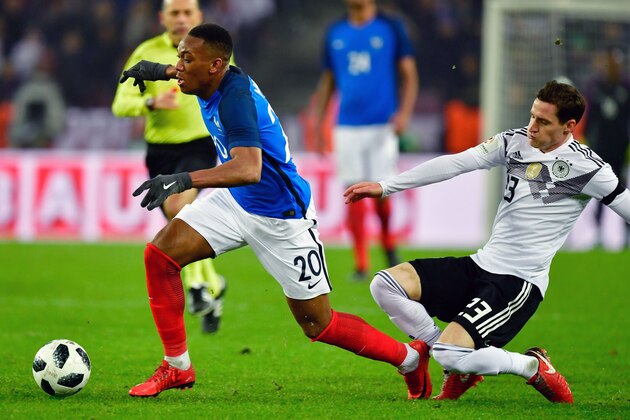 France's forward Anthony Martial (L) is fouled by Germany's midfielder Sebastian Rudy during the international friendly football match Germany against France in Cologne on November 14, 2017.
The match ended 2-2. / AFP PHOTO / John MACDOUGALL        (Photo credit should read JOHN MACDOUGALL/AFP/Getty Images)