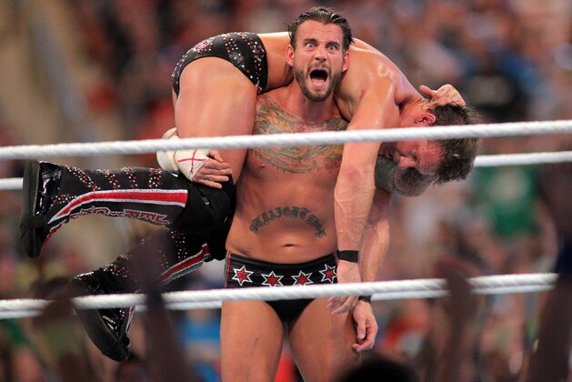 FILE - In this April 1, 2012, file photo, CM Punk competes against Chris Jericho at WrestleMania XXVIII in Sun Life Stadium in Miami Gardens, Fla. CM Punk making his debut as a mixed martial arts fighter on Saturday night in UFC 203. (AP Photo/AP Images for Wreslemania, Marc Serota, File)