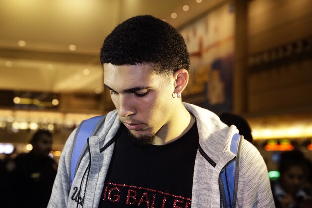 UCLA basketball player LiAngelo Ball keeps his head down as he leaves Los Angeles International Airport on Tuesday, Nov. 14, 2017, in Los Angeles. Three UCLA basketball players detained in China on suspicion of shoplifting returned home, where they may be disciplined by the school as a result of the international scandal. (AP Photo/Jae C. Hong)