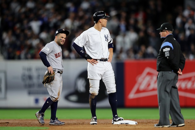 NEW YORK, NY - OCTOBER 16:  Jose Altuve #27 of the Houston Astros and Aaron Judge #99 of the New York Yankees look on during the third inning in Game Three of the American League Championship Series at Yankee Stadium on October 16, 2017 in the Bronx borough of New York City.  (Photo by Elsa/Getty Images)