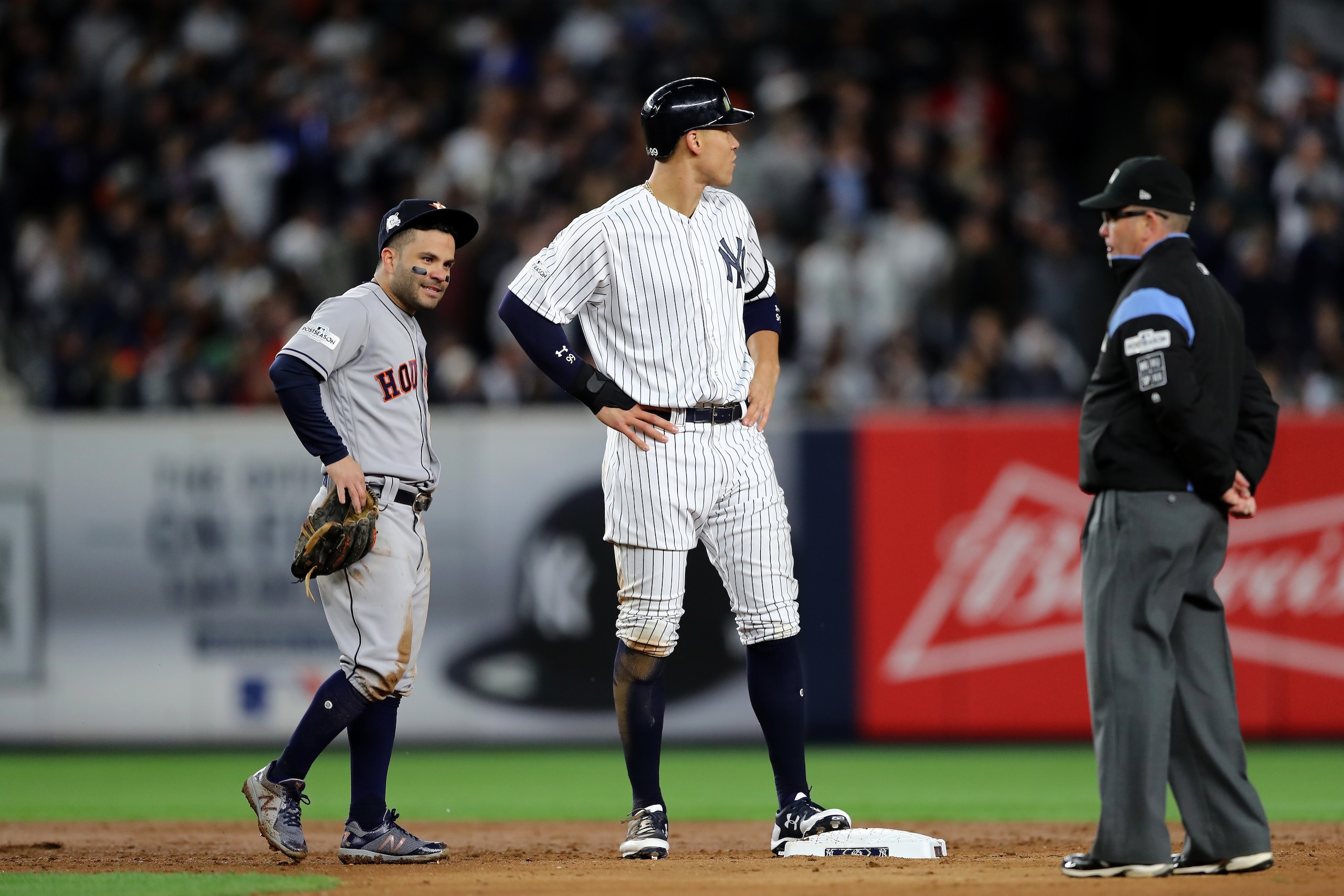 NEW YORK, NY - OCTOBER 16:  Jose Altuve #27 of the Houston Astros and Aaron Judge #99 of the New York Yankees look on during the third inning in Game Three of the American League Championship Series at Yankee Stadium on October 16, 2017 in the Bronx borough of New York City.  (Photo by Elsa/Getty Images)