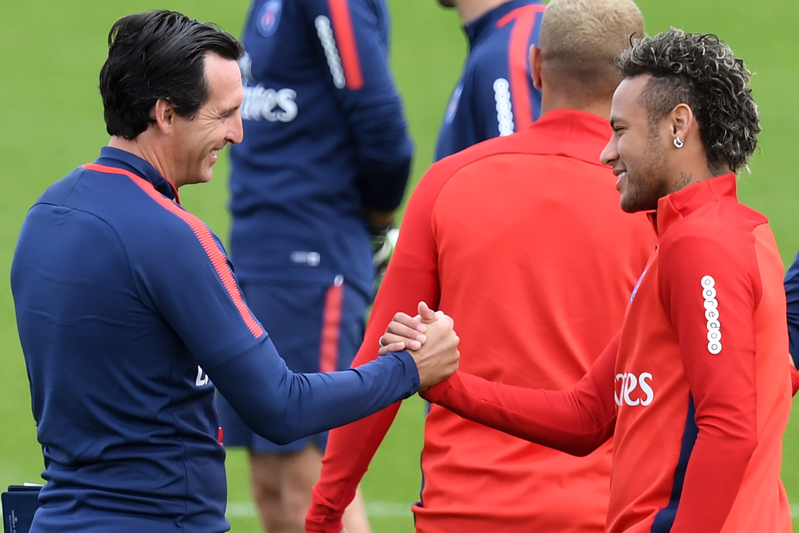 Paris Saint-Germain's Brazilian forward Neymar (R) shakes hands with Paris Saint-Germain's Spanish head coach Unai Emery (L) during a training session at the Camp des Loges in Saint-Germain-en-Laye, near Paris, on August 11, 2017.  / AFP PHOTO / ALAIN JOCARD        (Photo credit should read ALAIN JOCARD/AFP/Getty Images)