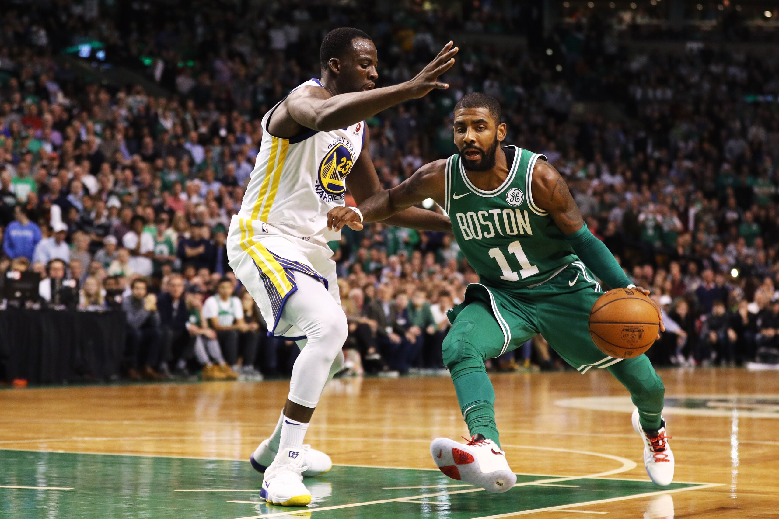 BOSTON, MA - NOVEMBER 16: Kyrie Irving #11 of the Boston Celtics drives against Draymond Green #23 of the Golden State Warriors during the fourth quarter at TD Garden on November 16, 2017 in Boston, Massachusetts. The Celtics defeat the Warriors 92-88. (Photo by Maddie Meyer/Getty Images)