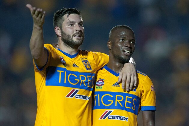 Tigres' Enner Valencia (R) celebrates with his teammate Andre Pierre Gignac after scoring against Necaxa during the 2017 Mexican Apertura tournament football match, at Universitario stadium in Monterrey, Mexico on November 5, 2017.  / AFP PHOTO / JULIO AGUILAR        (Photo credit should read JULIO AGUILAR/AFP/Getty Images)