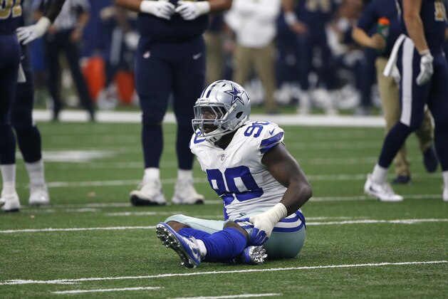 Dallas Cowboys defensive end DeMarcus Lawrence (90) lays on the field with an unknown injury during an NFL football game against the Los Angeles Rams on Sunday, Oct. 1, 2017, in Arlington, Texas. (AP Photo/Ron Jenkins)