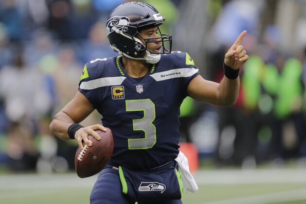 Seattle Seahawks quarterback Russell Wilson drops to pass against the Washington Redskins, Sunday, Nov. 5, 2017, in Seattle. (AP Photo/Stephen Brashear)